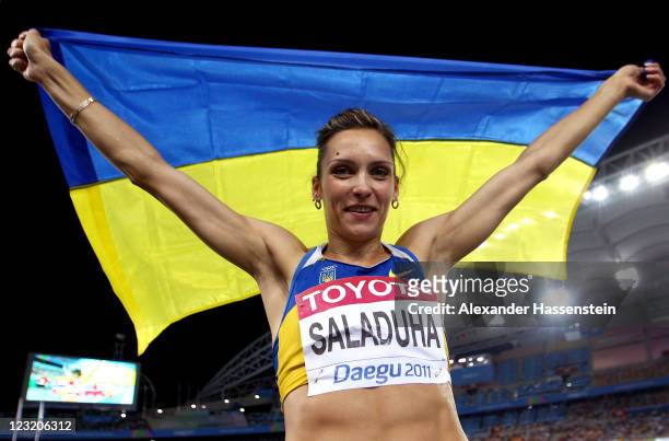 Olha Saladuha of Ukraine celebrates after claiming gold in the women's triple jump final during day six of the 13th IAAF World Athletics...