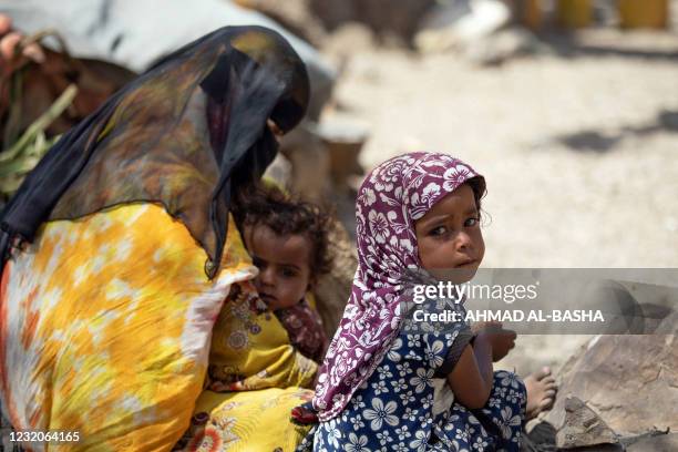 Displaced Yemeni family, who fled their homes due to fighting between Huthi rebels and the Saudi-backed government forces, take shelter under a tree...