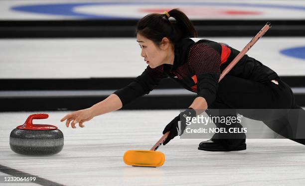 Chinese player takes part in a curling test event for the 2022 Beijing Winter Olympic Games at the National Aquatics Center, known as the Ice Cube,...