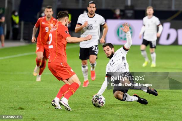 Egzon Bejtulai of North Macedonia and Amin Younes of Germany battle for the ball during the FIFA World Cup 2022 Qatar qualifying match between...