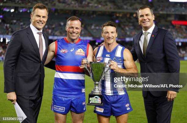 Luke Darcy, Brad Johnson, Brent Harvey and Wayne Carey pose for a photograph during the 2021 AFL Round 03 match between the North Melbourne Kangaroos...