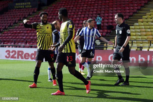 Nathaniel Chalobah and Ismaila Sarr of Watford celebrate the opening goal as Sam Hutchinson of Sheffield Wednesday complains to Referee Chris...