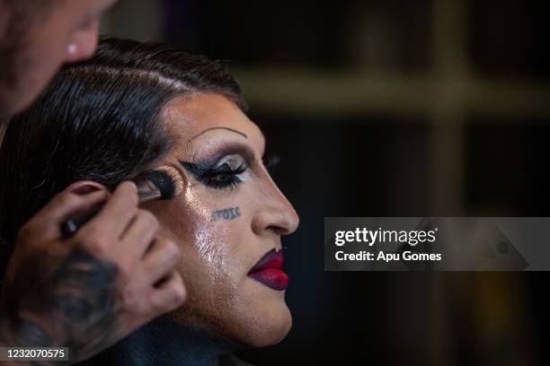 Diego Garijo poses to the makeup artist Carlos Gonzales while he works to transform Diego in his alter Ego, Lola Pistola at his house on April 01,...