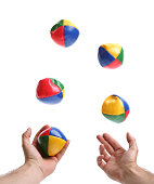 Two hands juggling set of five colorful bean balls