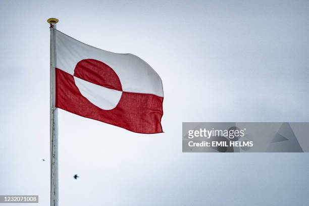 The Greenlandic flag called Erfalasorput flutters in Nuuk, Greenland, on April 2 days before parliamentary elections. - The autonomous Danish...