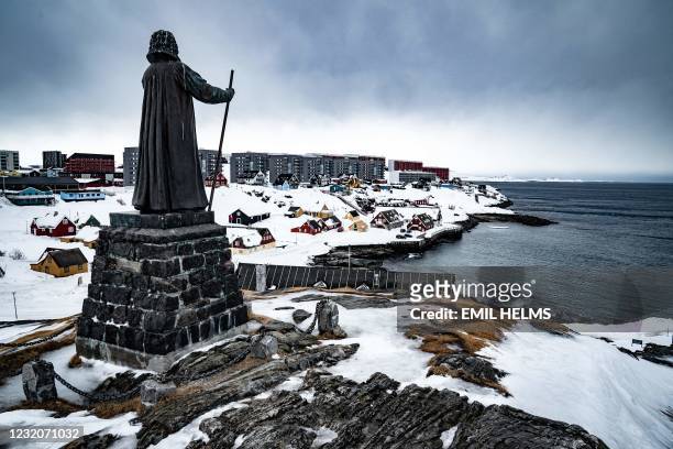 The statue of the Danish-Norwegian Lutheran missionary Hans Egede in Nuuk, Greenland, is pictured on March 30 days before parliamentary elections. -...