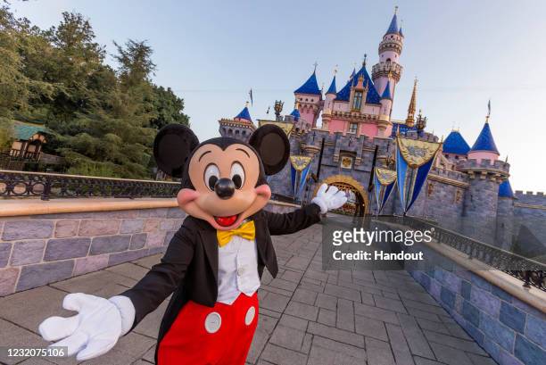 Mickey Mouse poses in front of Sleeping Beauty Castle at Disneyland Park on August 27, 2019 in Anaheim, California. Disneyland plans to reopen on...