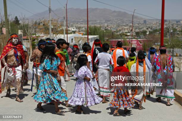 Members of the Raramuri ethnic group dance during Good Friday celebrations at the Tarahumara neighborhood in Ciudad Juarez, Chihuahua state, Mexico,...