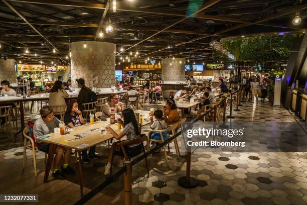 Customers dine at a food court inside the K11 Musea shopping mall, developed by K11 Group Ltd., a unit of New world Development Co., in Hong Kong,...