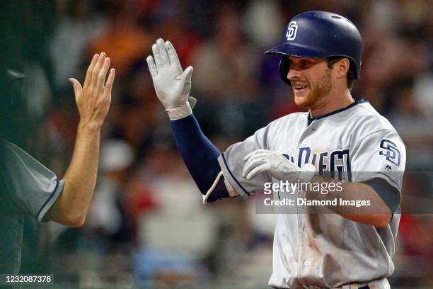 Third baseman Cory Spangenberg of the San Diego Padres celebrates outside the dugout after hitting a two-run home run in the seventh inning of a game...