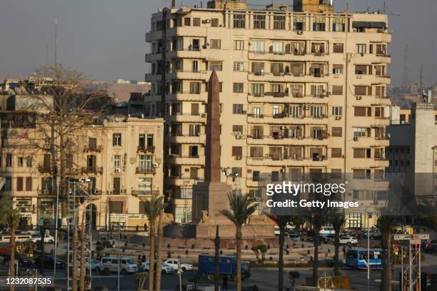 Shows a view of the Obelisk of Ramses II, surrounded by the recently-unveiled and restored four ancient sandstone sphinxes extracted from the Avenue...