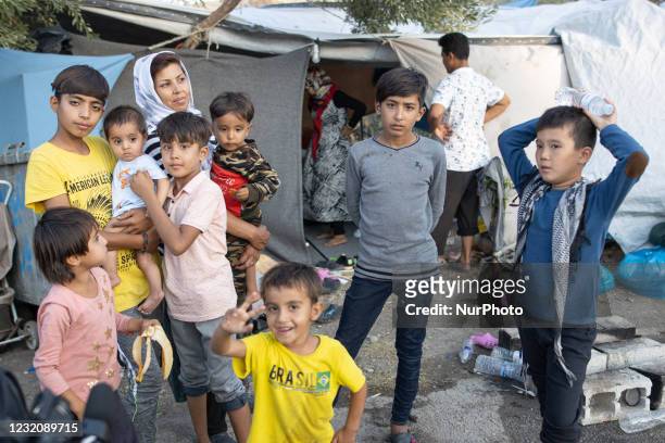 Refugee family as seen outside the tent they live after the fire. Close up of underaged, minors asylum seekers who live with their families around...