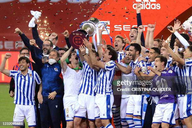 Real Sociedad's players celebrate with the trophy after winning the 2020 Spanish Copa del Rey final football match between Athletic Bilbao and Real...