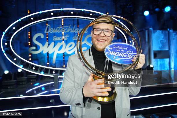 In this handout photo provided by TVNOW, Jan-Marten Block poses for photos with the trophy following the finals of the TV show "Deutschland sucht den...