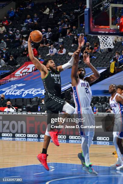 Karl-Anthony Towns of the Minnesota Timberwolves dunks the ball against Joel Embiid of the Philadelphia 76ers on April 3, 2021 at Wells Fargo Center...