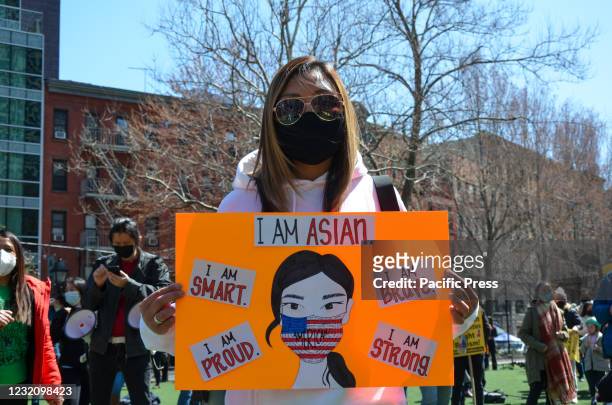 Participants are seen holding placards at Columbus Park in Lower Manhattan during Stop Asian Hate demonstration to show support to Asian community in...