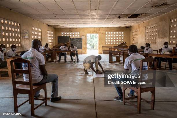 Community mobiliser" prepares a picture to point out areas of the body that are likely to spread Ebola during a training led by the charity Goal...