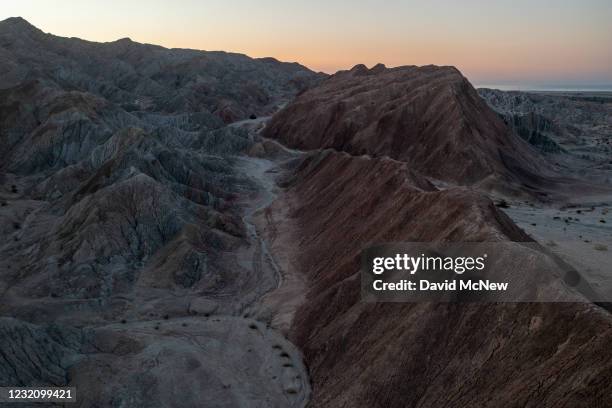 In an aerial view from a drone, colorful minerals are seen on the Pacific Plate side of the San Andreas Fault, where it collides with the North...