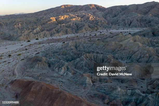 In an aerial view from a drone, colorful minerals are seen on the Pacific Plate side of the San Andreas Fault, where it collides with the North...