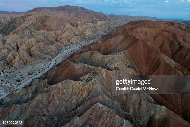 In an aerial view from a drone, colorful minerals are seen on the Pacific Plate side of the San Andreas Fault, where it collides with the North...