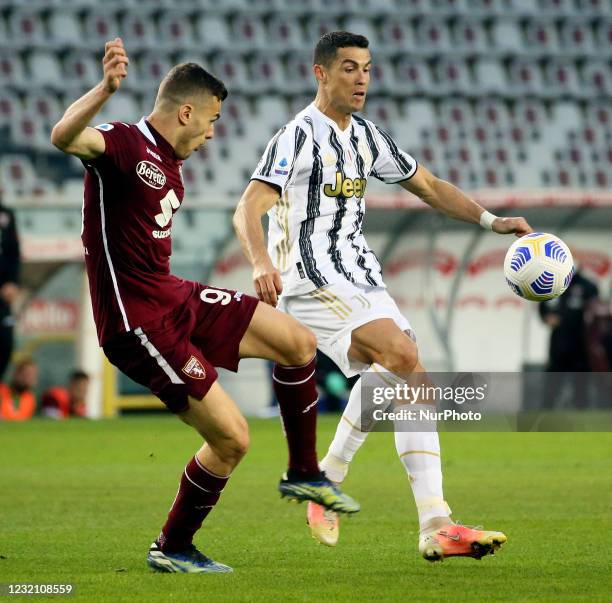 Alessandro Buongiorno of Torino FC competes for the ball with Cristiano Ronaldo of Juventus during the Serie A match between Torino FC and Juventus...