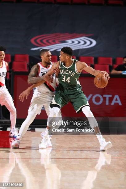 Damian Lillard of the Portland Trail Blazers plays defense on Giannis Antetokounmpo of the Milwaukee Bucks during the game on April 2, 2021 at the...