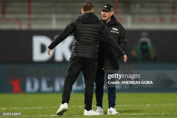 Union Berlin's Swiss head coach Urs Fischer and Hertha Berlin's Hungarian head coach Pal Dardai speak after the German first divison Bundesliga...