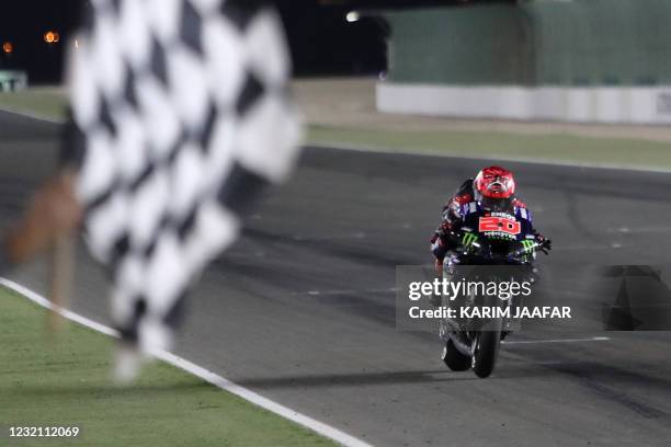 Monster Energy Yamaha MotoGP's French rider Fabio Quartararo crosses the checkered flag to win the Moto GP Grand Prix of Doha at the Losail...