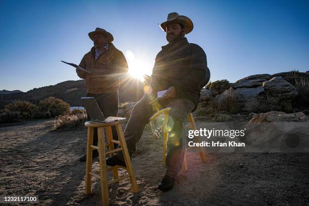 Home missionary Larry Craig, left, flanked by his son Larry Craig, singing hymns, holds yearly sunrise Easter service on Sunrise Rock in the Mojave...