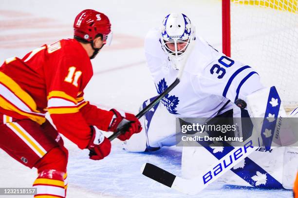 Mikael Backlund of the Calgary Flames takes a shot on the net of Michael Hutchinson of the Toronto Maple Leafs during the first period of an NHL game...