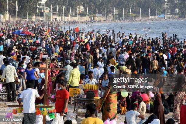 People are seen enjoying the warm weather at Juhu beach in Mumbai. Despite the rise in coronavirus cases, people are not following the guidelines of...