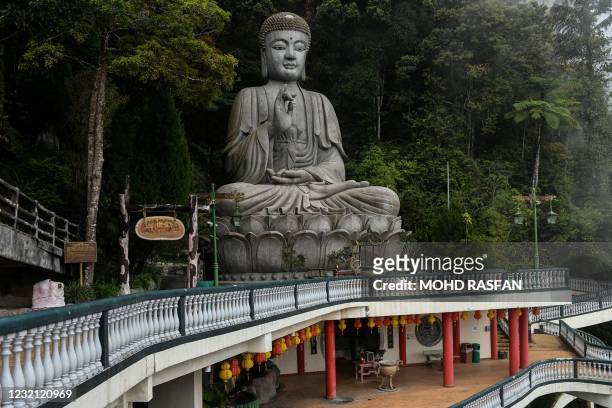 Buddha statue is pictured at the Chin Swee Caves Temple, nearly empty due to partial lockdown rules set by authorities restricting travel within each...