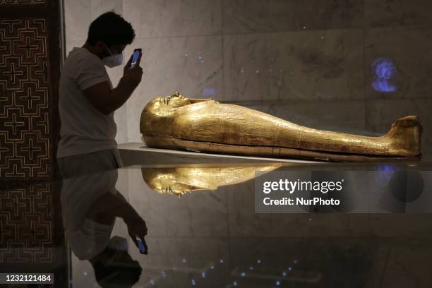 Man take photo of statue is displayed at Egypt's new National Museum of Egyptian Civilisation , in the Fustat district of Old Cairo, Egypt, during...