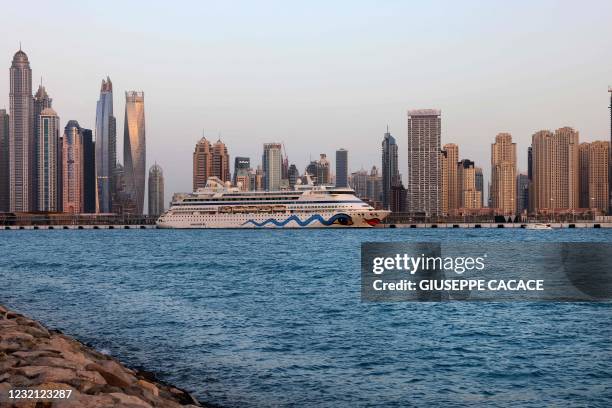 Picture taken on April 4, 2021 shows the AIDAvita cruise ship, of German cruise line "AIDA Cruises", anchored off the new harbour in front of Dubai...