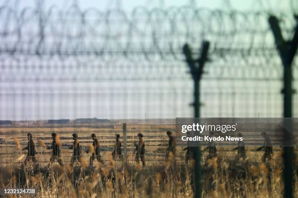 Photo taken from Dandong, China, shows North Korean soldiers patrolling in a border area with China on March 22, 2021.