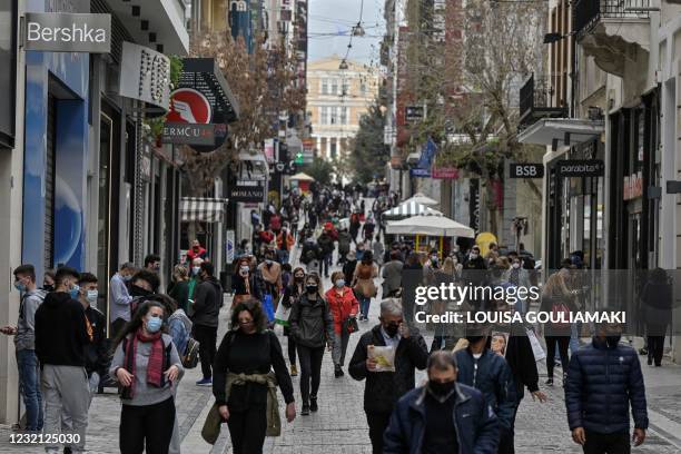 People walk down Athens main commercial street, on the first day of the reopening of retail stores on April 5, 2021 amid the coronavirus pandemic.