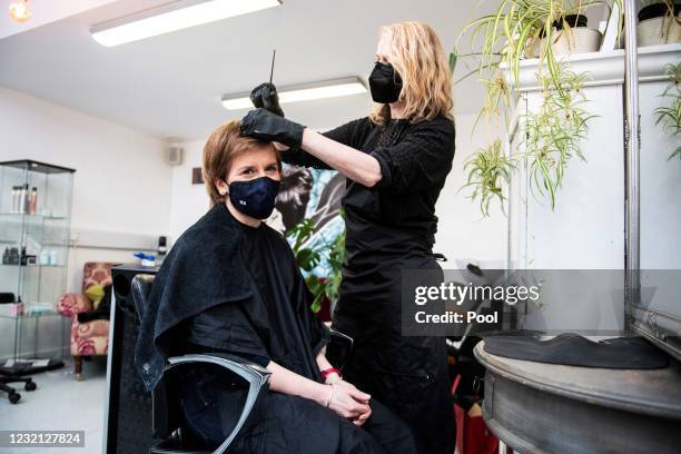 Scotland's First Minister Nicola Sturgeon, wearing a face covering, has her hair cut by Julie McGuire at Beehive Hair and Makeup hairdressers salon...