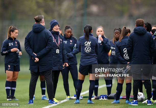France's women national football team head coach Corinne Diacre talks to her players during a training session in Clairefontaine-en-Yvelines, near...