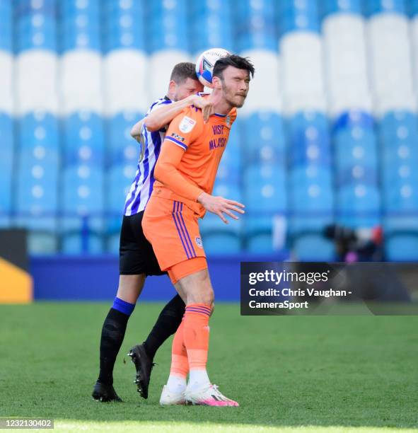 Sheffield Wednesday's Sam Hutchinson vies for possession with Cardiff City's Kieffer Moore during the Sky Bet Championship match between Sheffield...