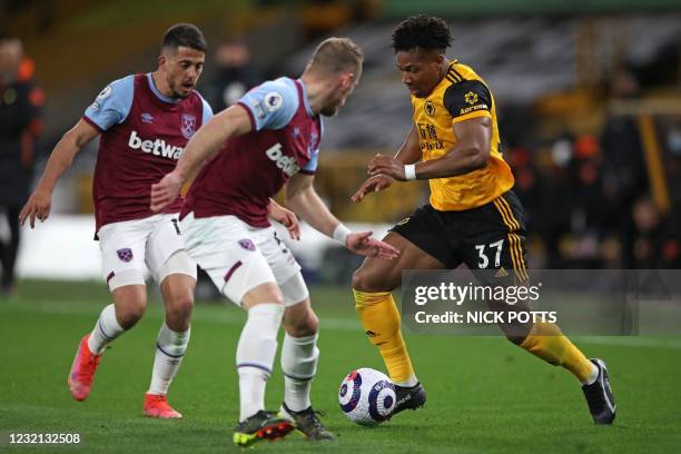 Wolverhampton Wanderers' Spanish midfielder Adama Traore vies with West Ham United's Czech defender Vladimir Coufal and West Ham United's Spanish...