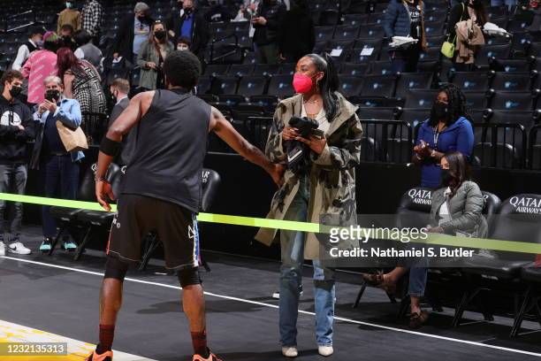Kyrie Irving of the Brooklyn Nets gives his jersey away to his sister Asia Irving after the game against the New York Knicks on April 5, 2021 at...