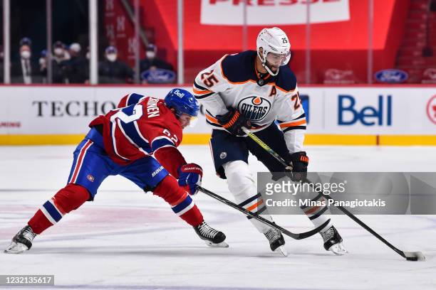 Artturi Lehkonen of the Montreal Canadiens challenges Darnell Nurse of the Edmonton Oilers during the third period at the Bell Centre on April 5,...