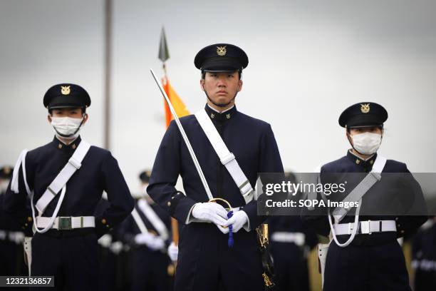 Students of the National Defense Academy perform a military parade during the entrance ceremony. Japans Vice-minister of Defense Yasuhide Nakayama...