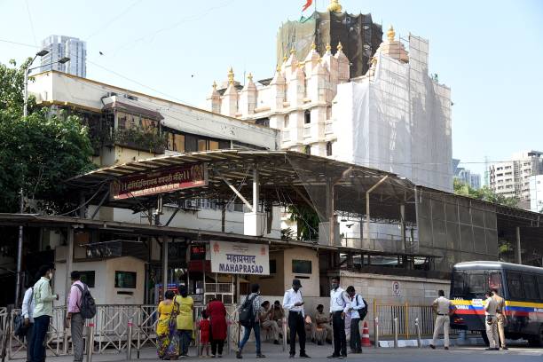 Devotees offer prayer outside the Siddhivinayak Ganapati Temple, closed due to Covid-19 coronavirus restrictions, in Mumbai on April 6, 2021.