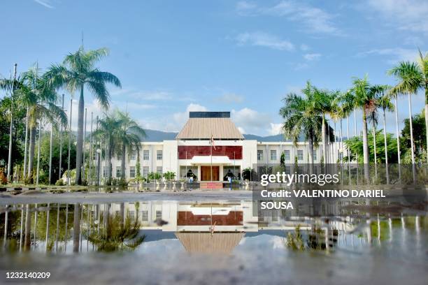 The Presidential Palace is reflected in water in Dili on April 6 after Tropical Cyclone Seroja battered the Southeast Asian nation, killing dozens...