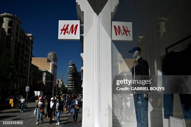 The logo of Swedish fashion retailer H&M is pictured outside a store in Madrid on April 06, 2021. Swedish fashion giant H&M is to lay off more than...