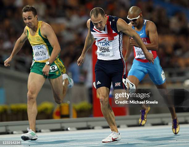 David Greene of Great Britain celebrates after crossing the finish line and claiming gold ahead of L.J. Van Zyl of South Africa and Felix Sanchez of...