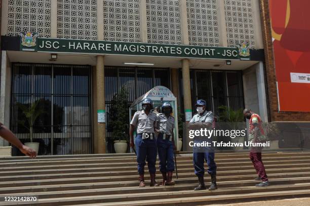 Police officers stand guard the entrance to the Magistrate court on April 6, 2021 in Harare, Zimbabwe. MDC Alliance activist Makomborero Haruzivishe...