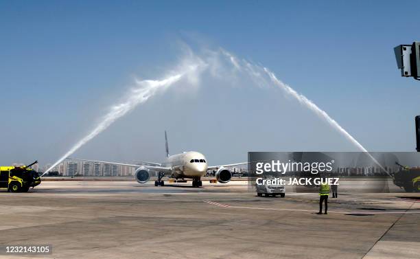 Water salute welcomes an Etihad Airways Boeing 787-9 "Dreamliner" aircraft after landing upon arrival from the United Arab Emirates at Israel's Ben...