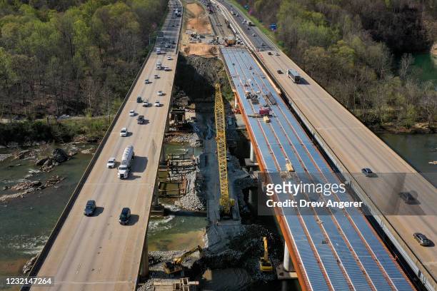 In an aerial view, vehicles on Interstate 95 travel past a construction project to add three lanes to the I-95 Rappahannock River Crossing on April...
